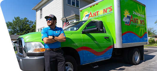 employee standing with company branded truck