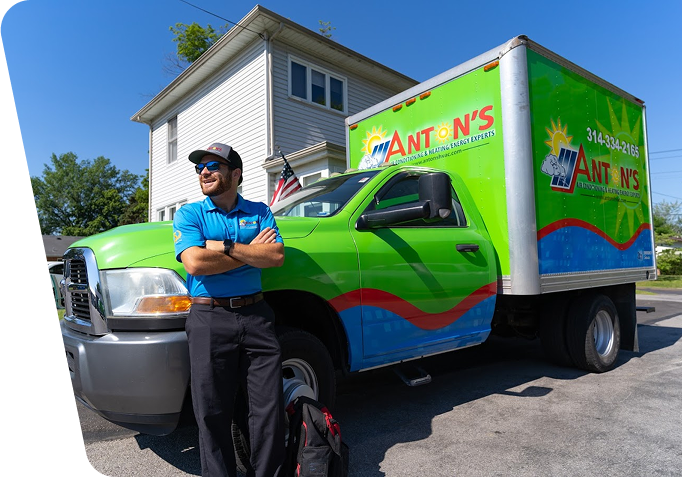 employee standing with company branded truck