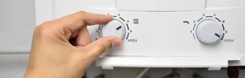Close up of a person adjusting the settings on a tankless water heater